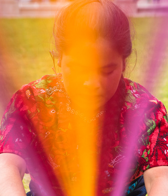 Photo of woman spinning a colorful item in front of her