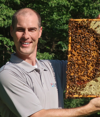 Photo of Tom Mooradian, from PepsiCo Recylcing, holding beehive