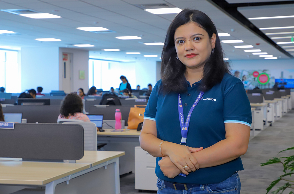 STEM associate Pragya Singh standing in office space