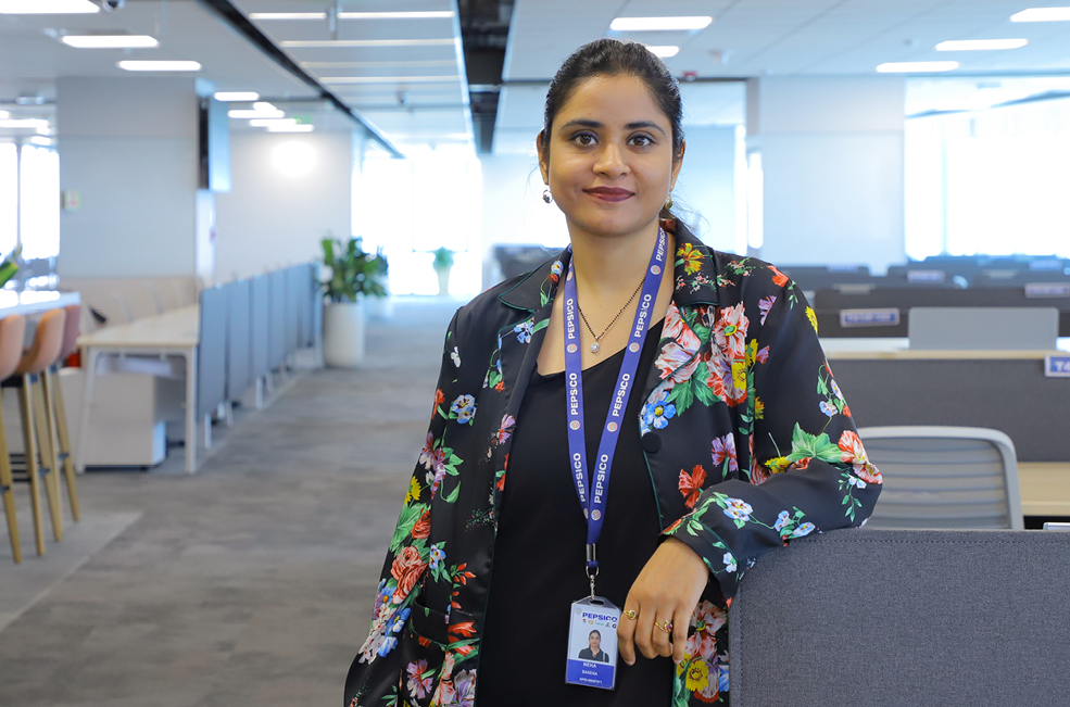 STEM associate Neha Saxena stands in office space